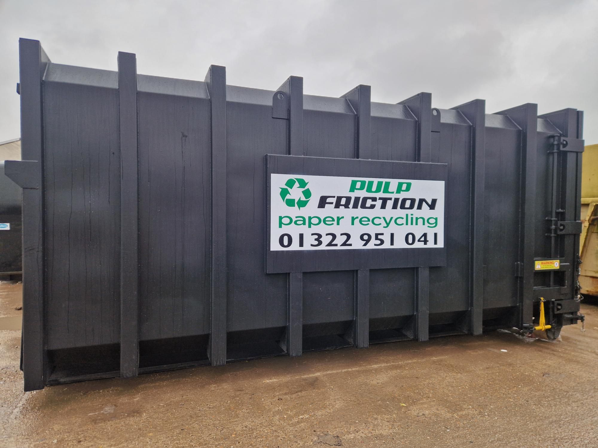 A static waste compactor on a loading dock